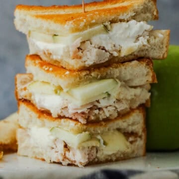 Chicken and apple sandwiches with cream cheese stacked.