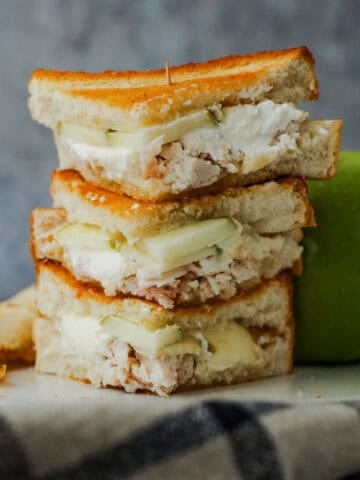Chicken and apple sandwiches with cream cheese stacked.