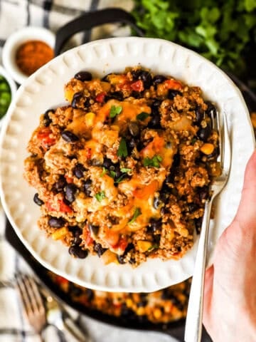 A plate filled with ground turkey, quinoa, beans, salsa, and cheese.