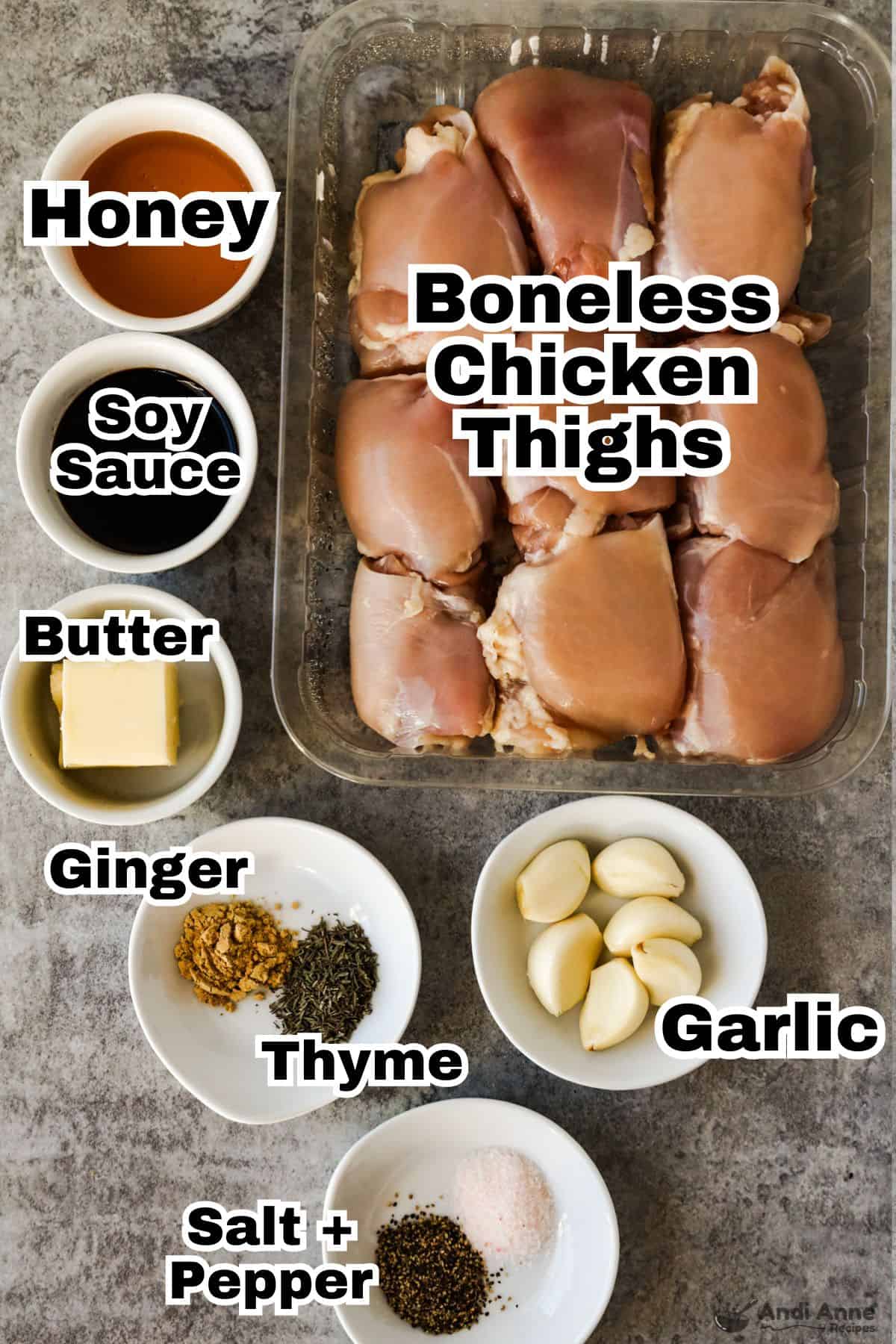 Various recipe ingredients in bowls and raw boneless chicken thighs