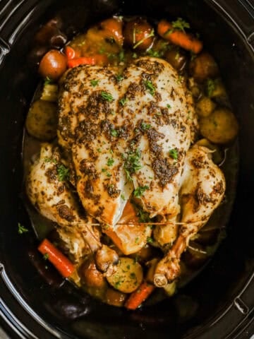 Roasted chicken and vegetables in a slow cooker.