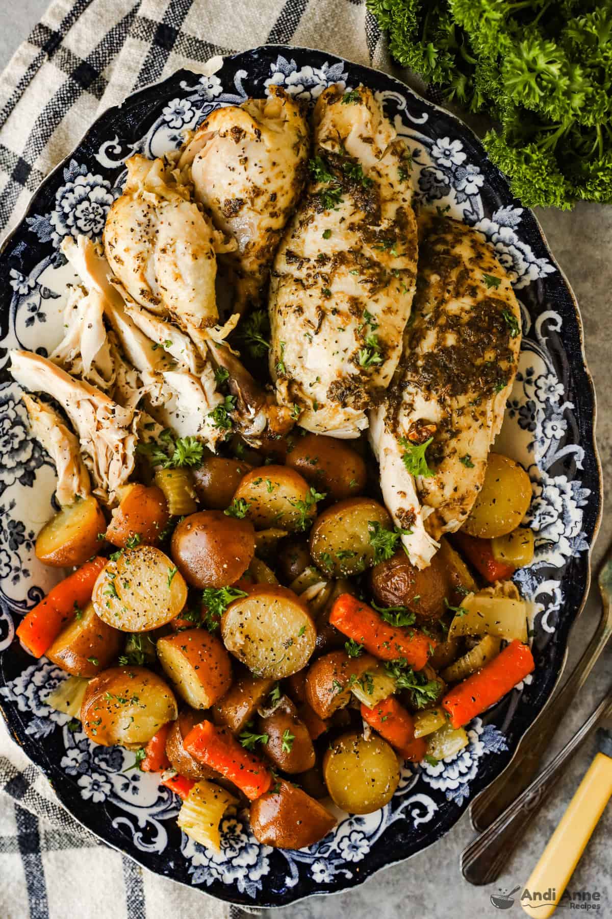 Slow cooker roasted chicken and vegetables on a serving platter.