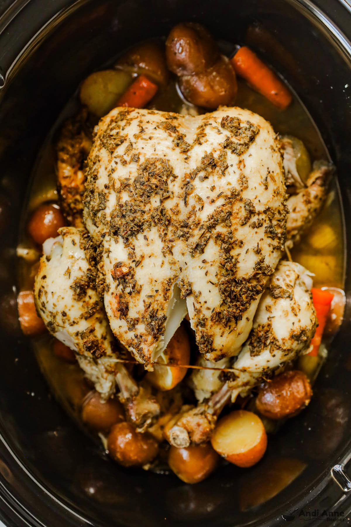 Roasted chicken and vegetables in a slow cooker.