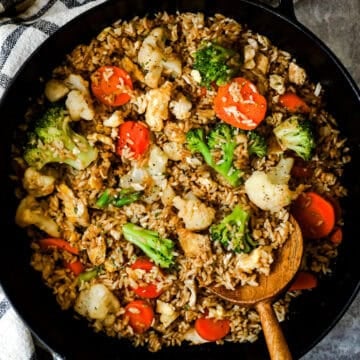 Egg fried rice with leftover broccoli, cauliflower, and carrots in a skillet.