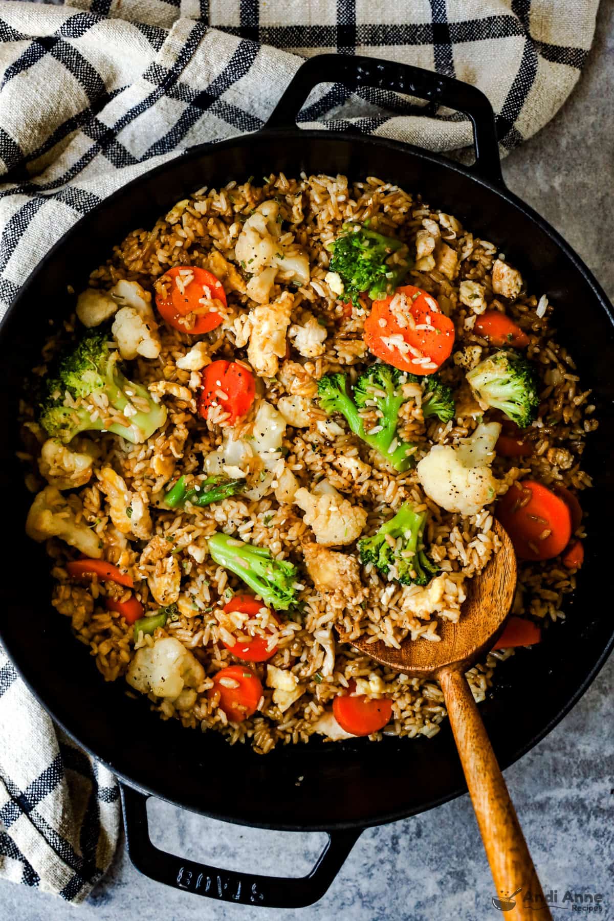 Egg fried rice with leftover broccoli, cauliflower, and carrots in a skillet.