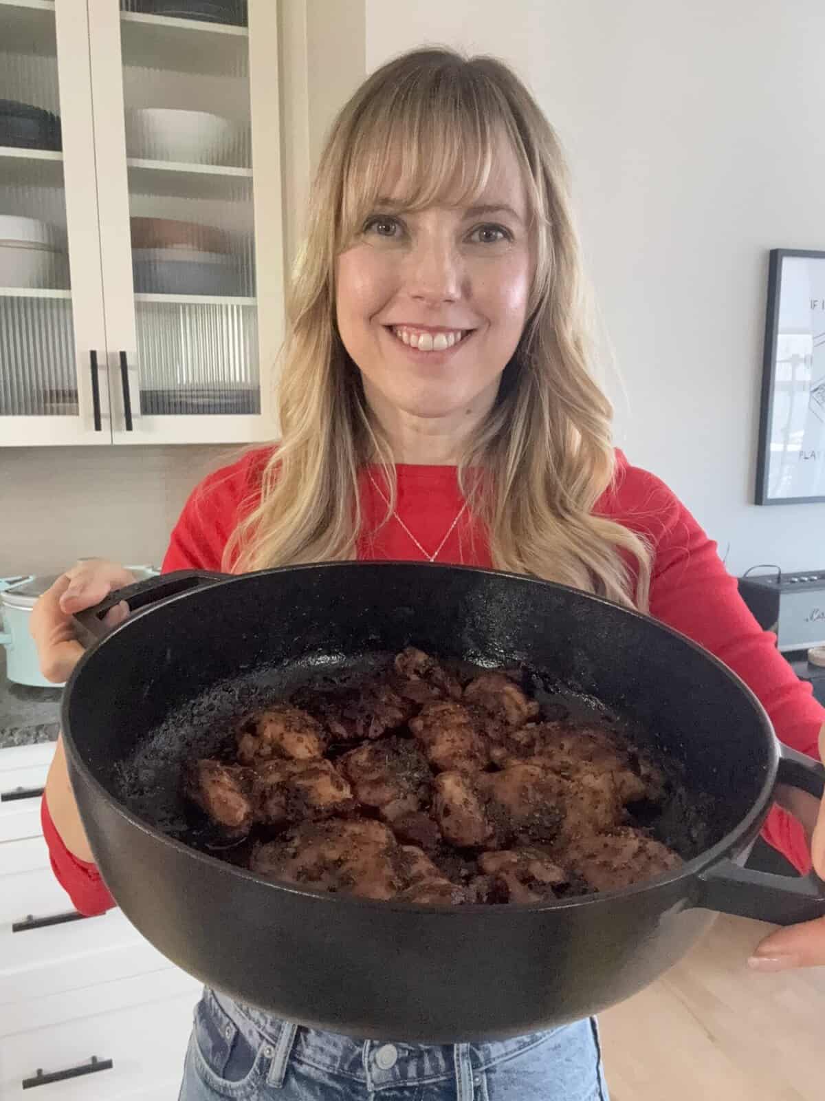 Andi holding pot of honey. garlic chicken thighs