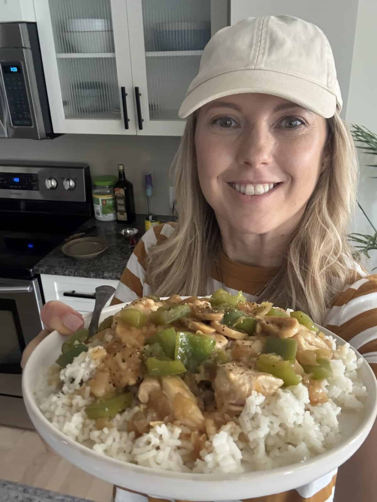 Andi Anne holding onion soup mushroom gravy chicken over rice