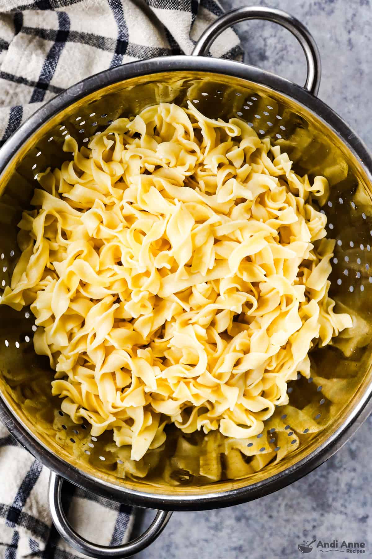 Egg noodles in a colander.