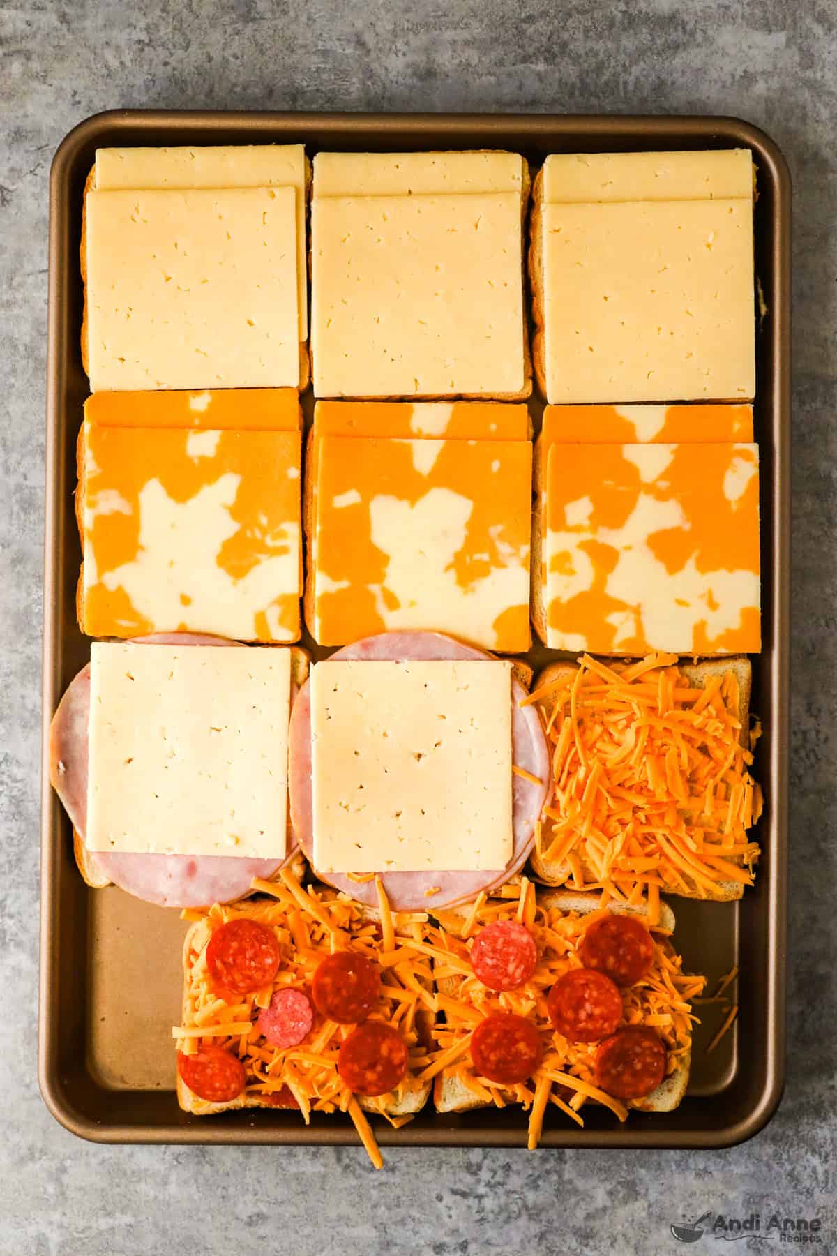 Slices of bread topped with sliced cheese, ham and sliced cheese, shredded cheddar, and pepperoni and shredded cheddar.