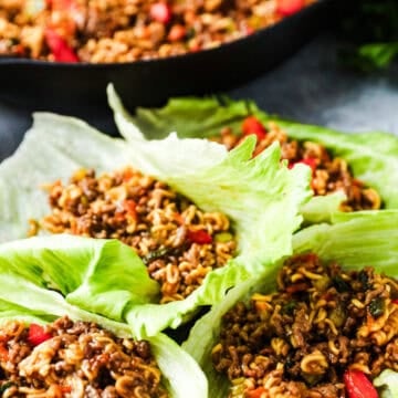 Lettuce leaves with ground beef, ramen noodles, and vegetables in a teriyaki sauce.