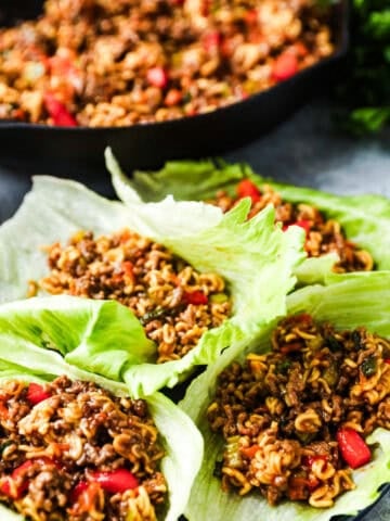 Lettuce leaves with ground beef, ramen noodles, and vegetables in a teriyaki sauce.