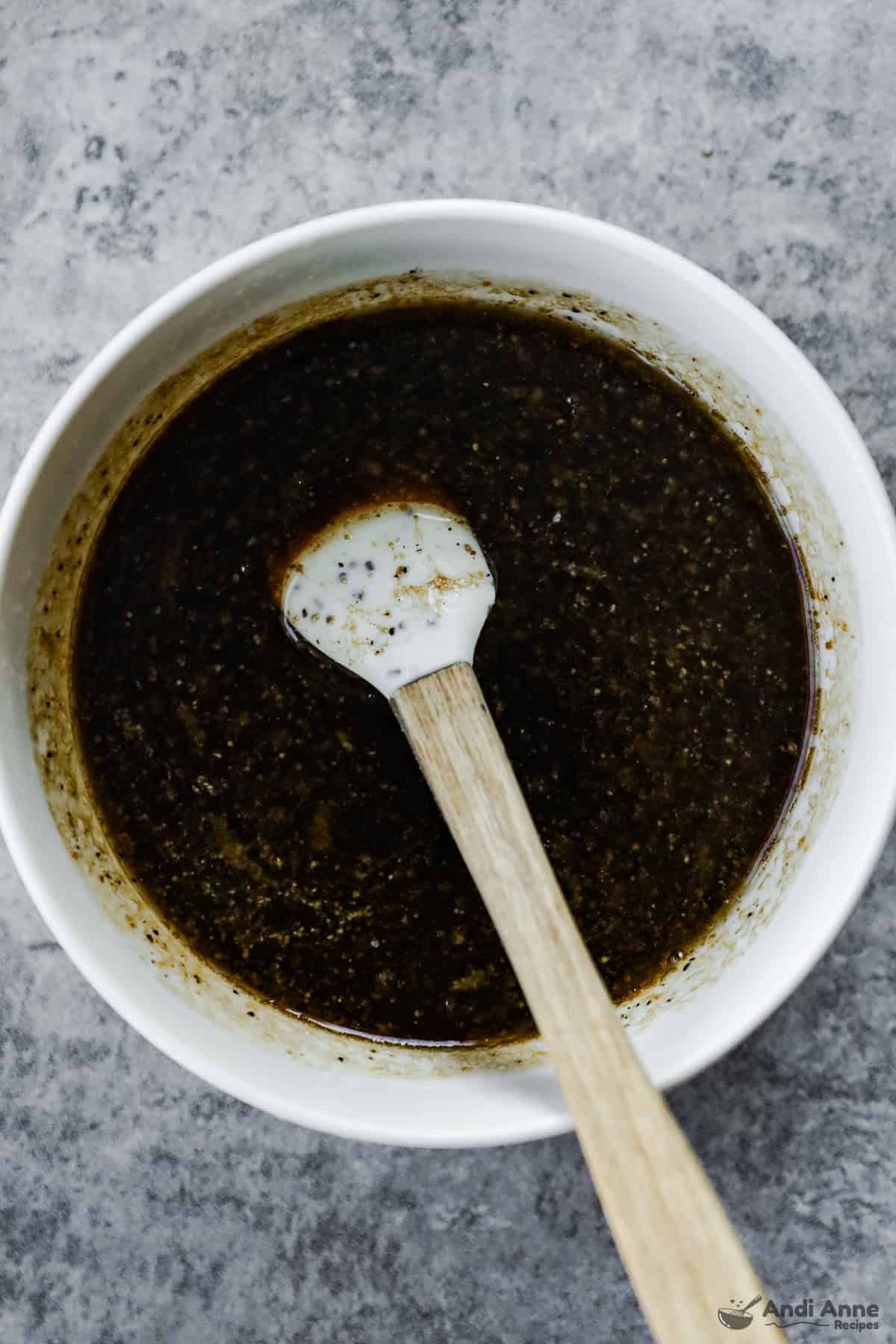 A bowl with soy sauce, brown sugar, garlic, and melted butter.