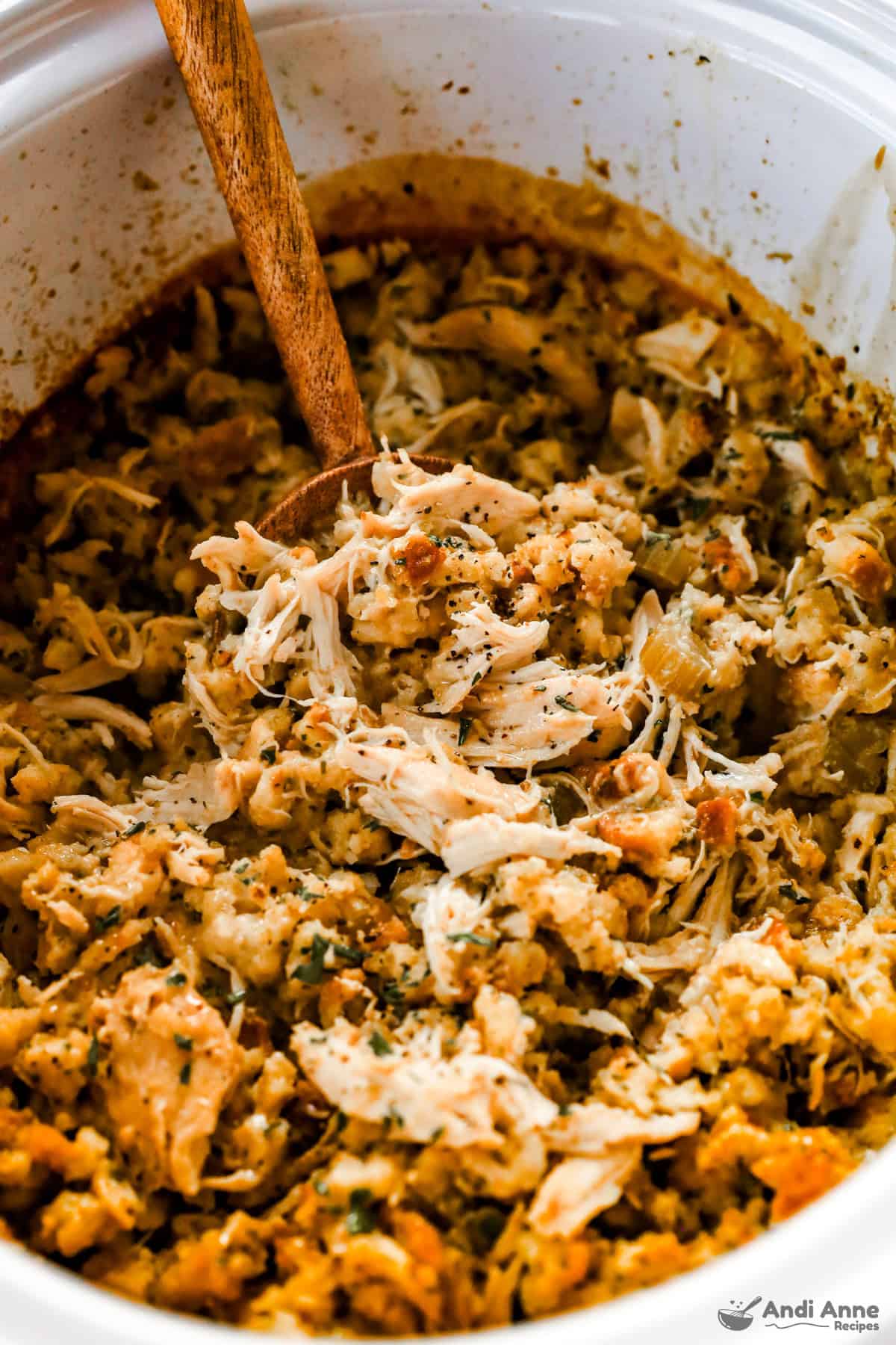 crockpot chicken and stuffing with wood spoon