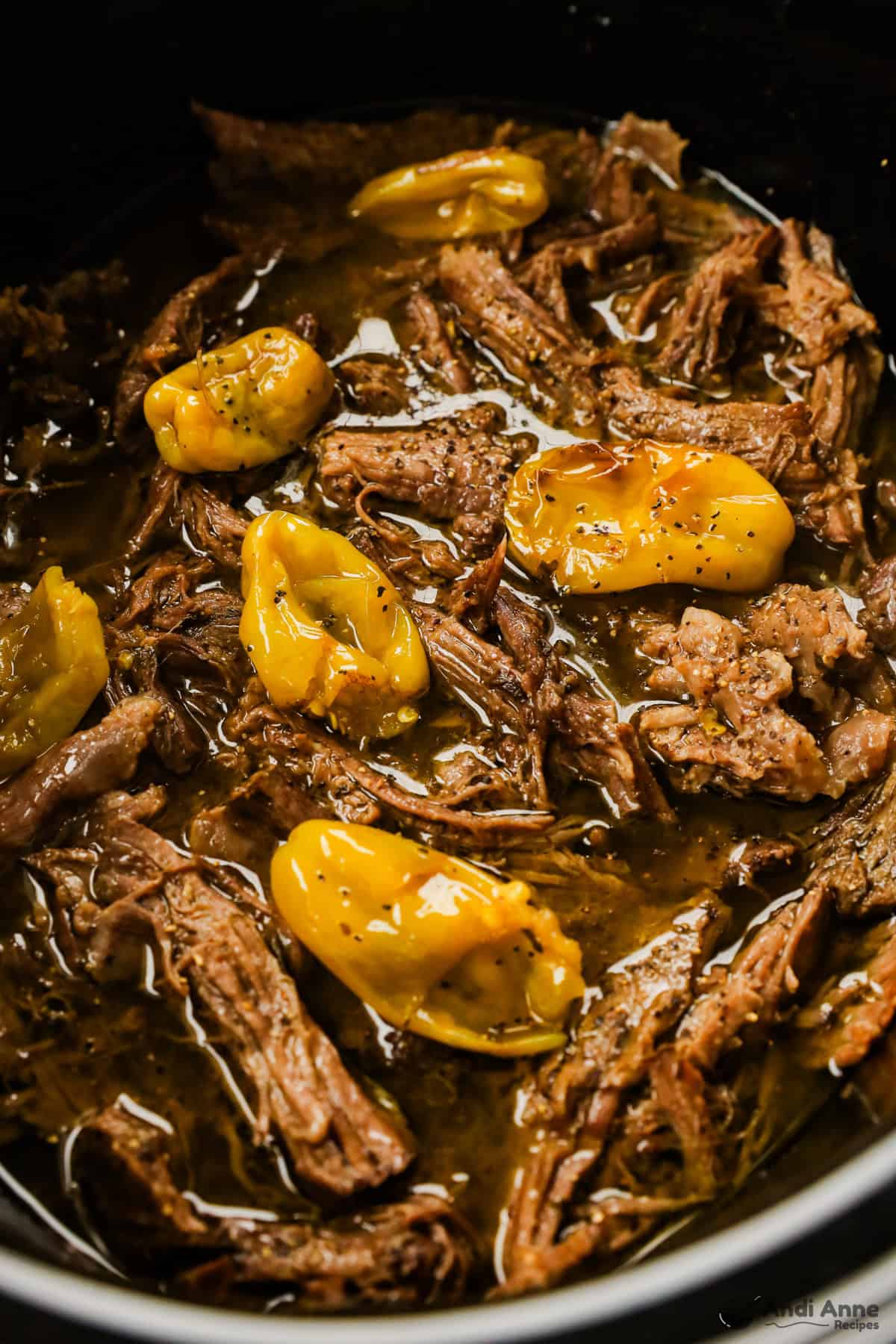 crockpot with shredded beef and pepperoncini peppers
