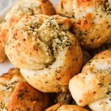 Garlic knots with parmesan cheese on a plate.