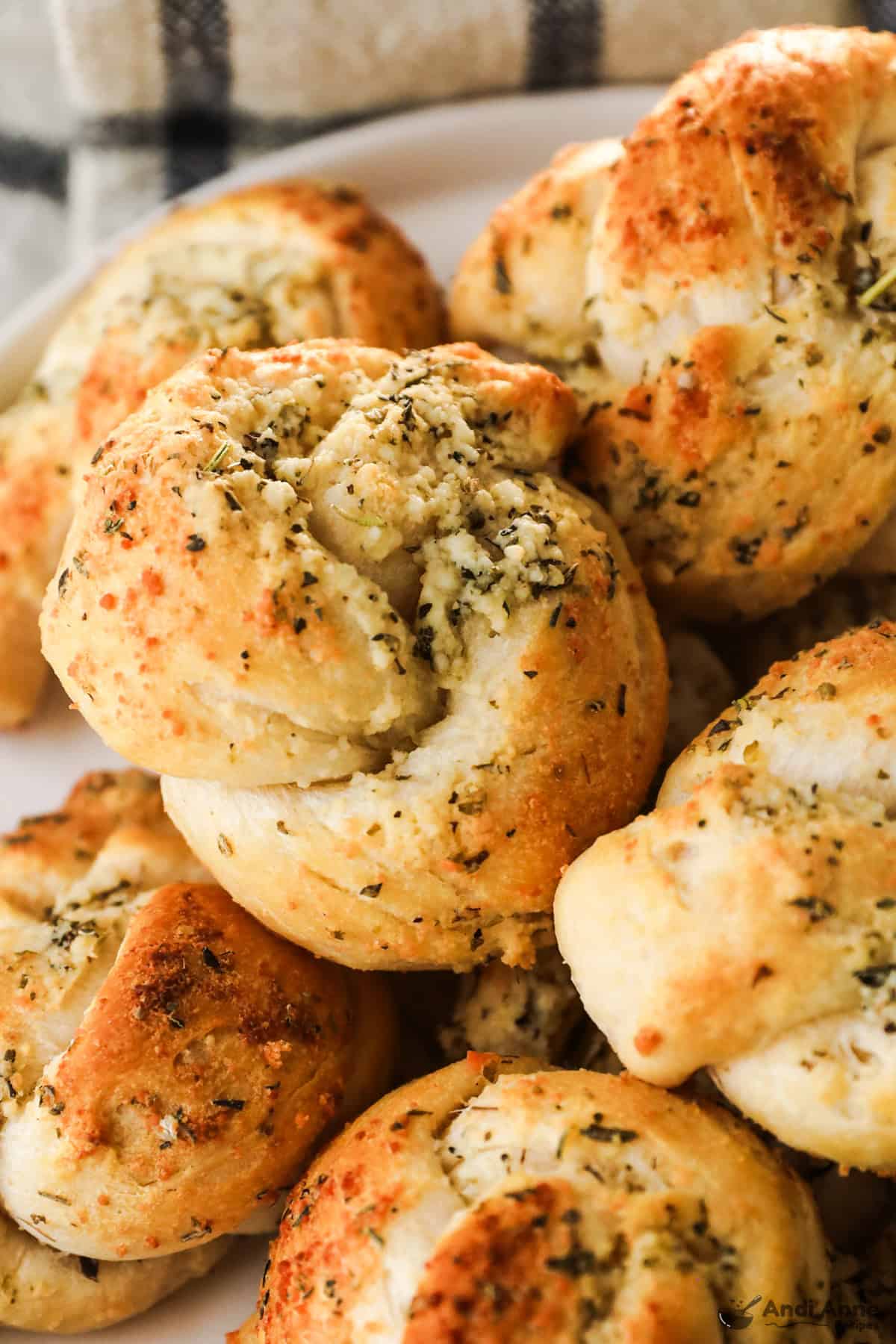 Garlic knots with parmesan cheese on a plate.