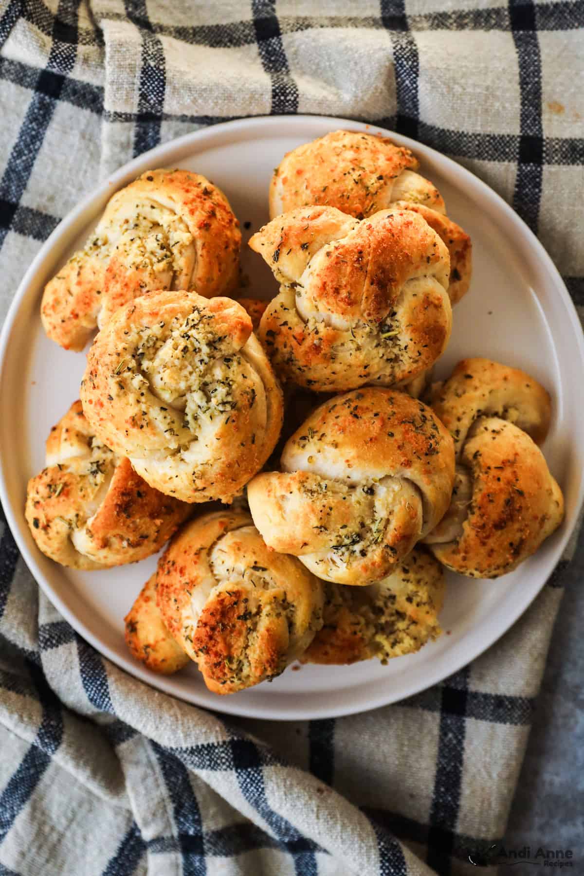 A batch of garlic knots on a plate.