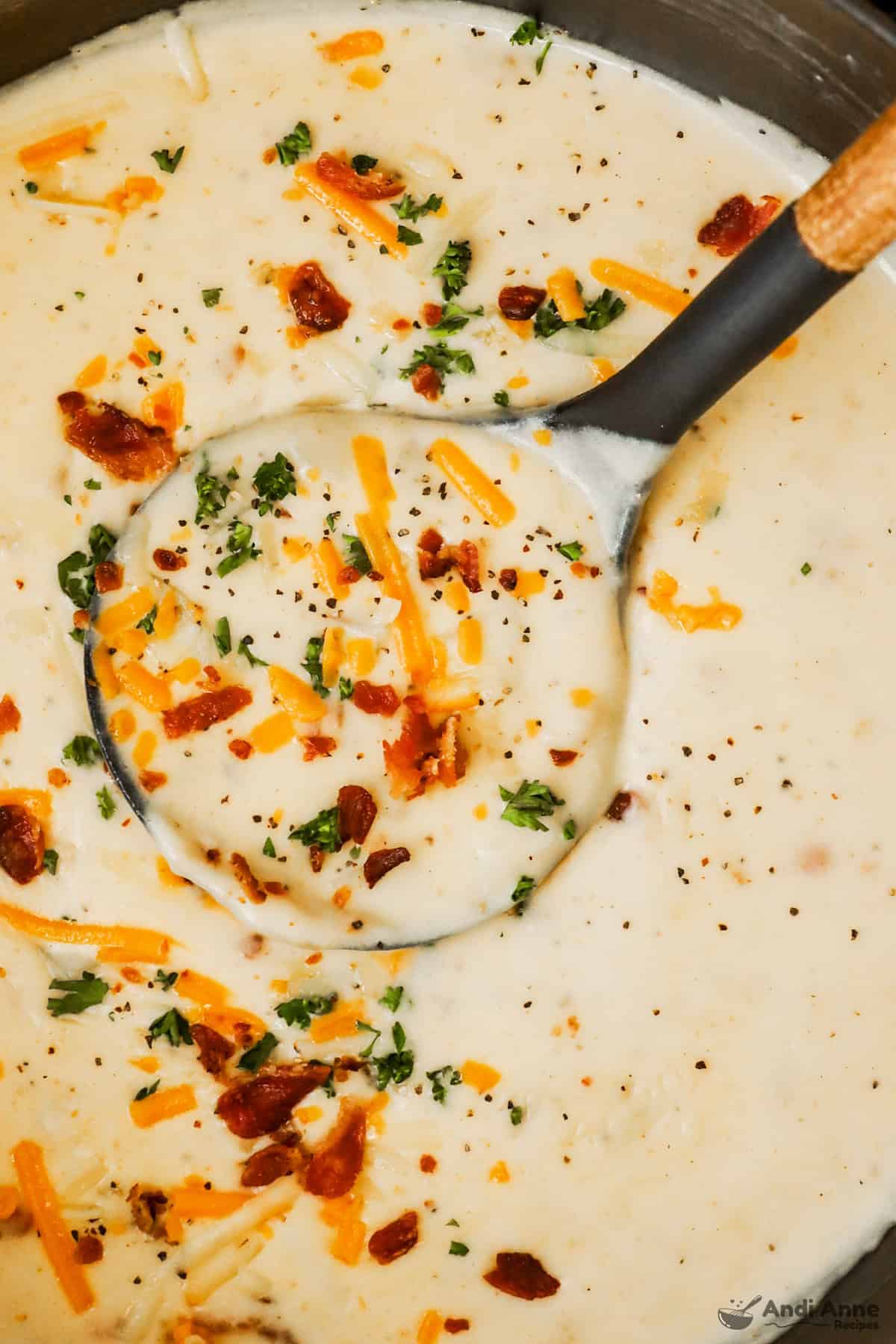 Loaded baked potato soup topped with cheddar cheese, bacon, and chives.