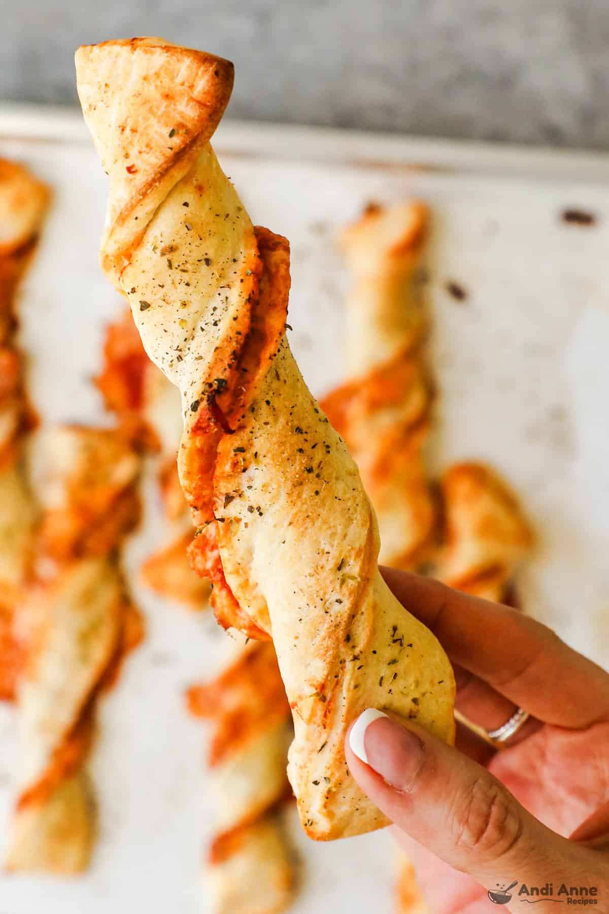 An up-close of a twisted pizza dough breadstick.