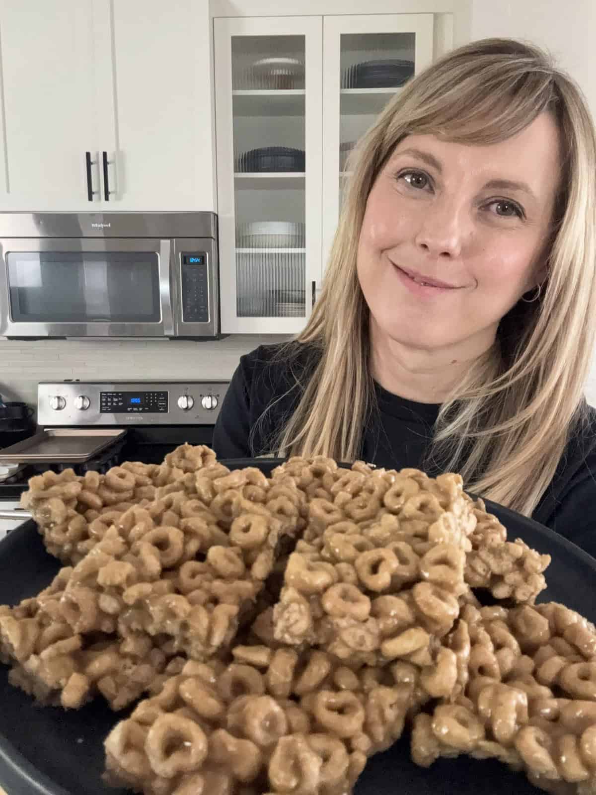Andi holding plate of homemade cereal bars