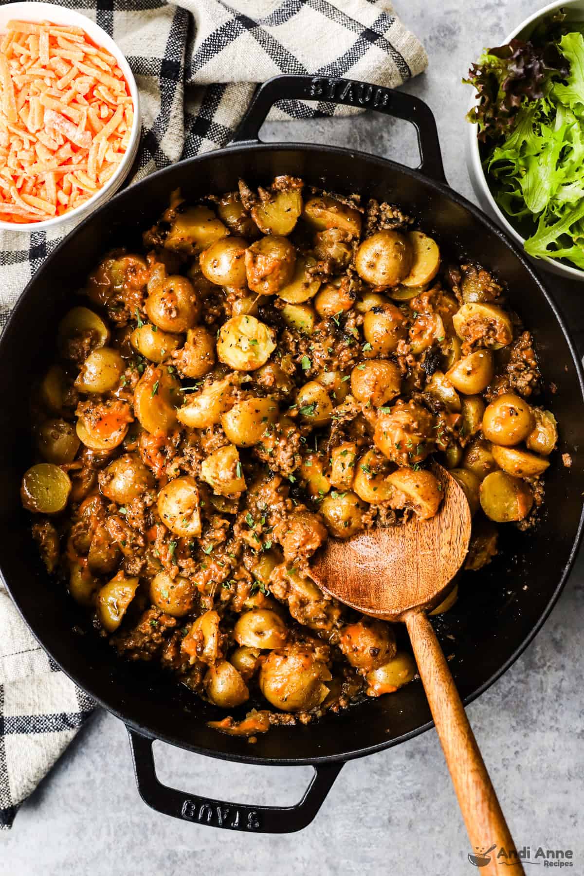 Black skillet with cheesy ground beef and baby potatoes