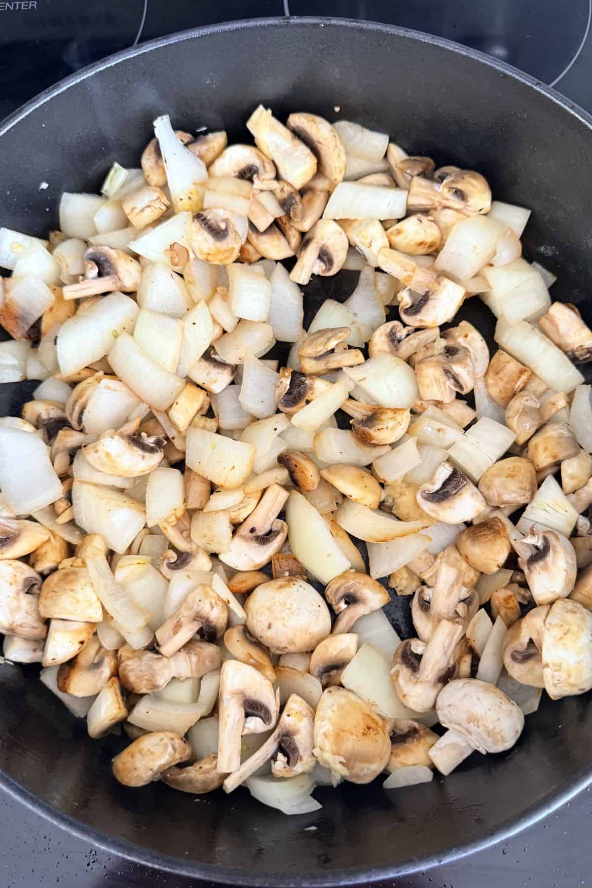 chopped onion and mushroom in pan