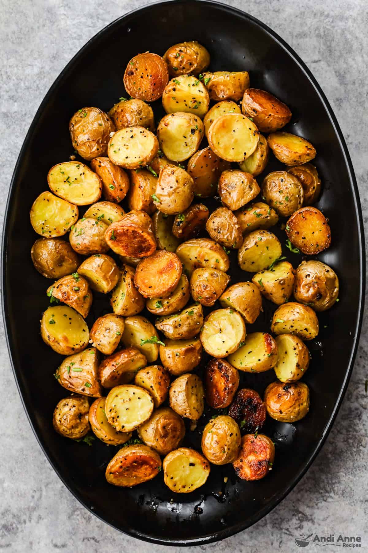 A large serving dish with crispy roasted baby potatoes.