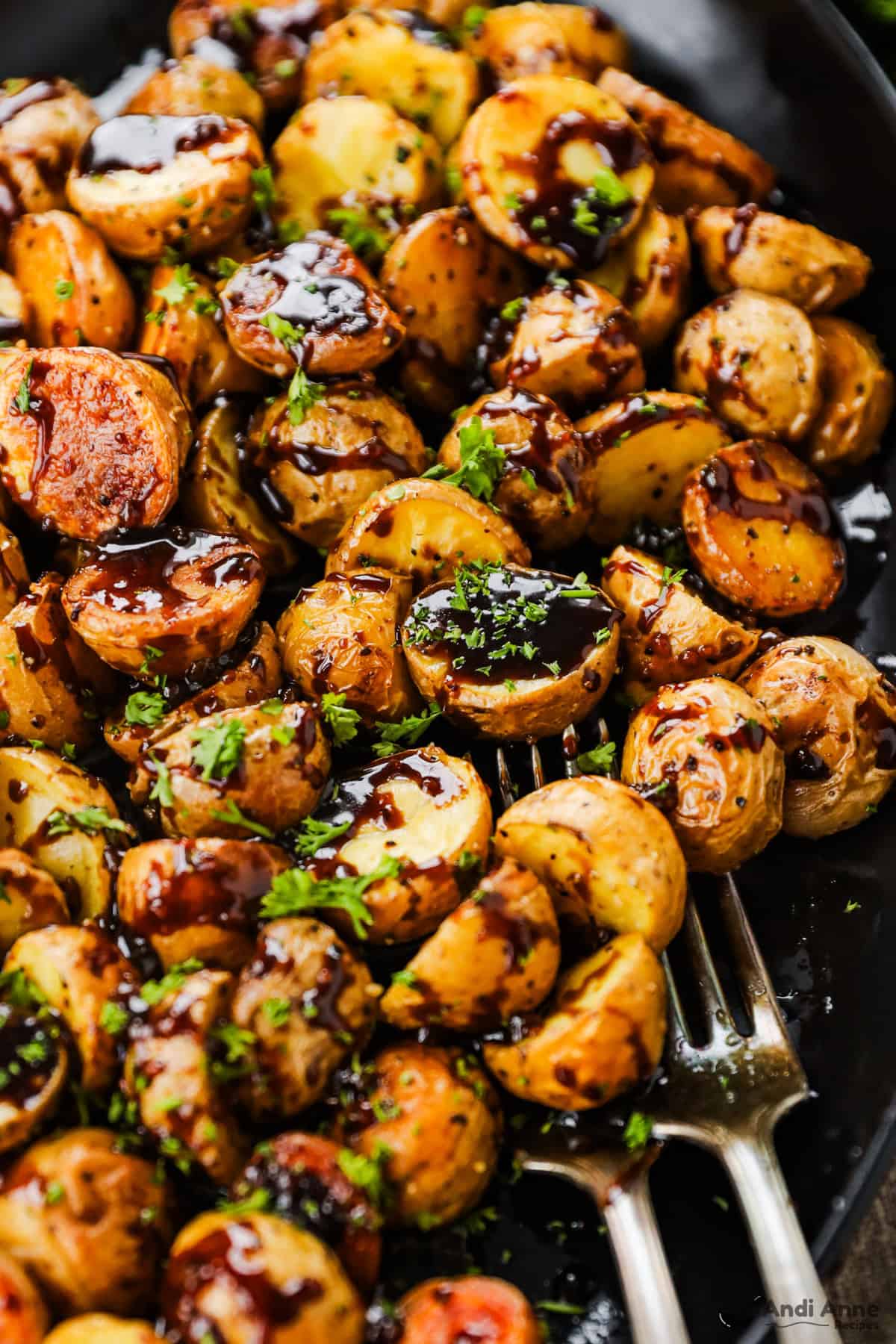 A close up of roasted baby potatoes in a honey balsamic glaze.