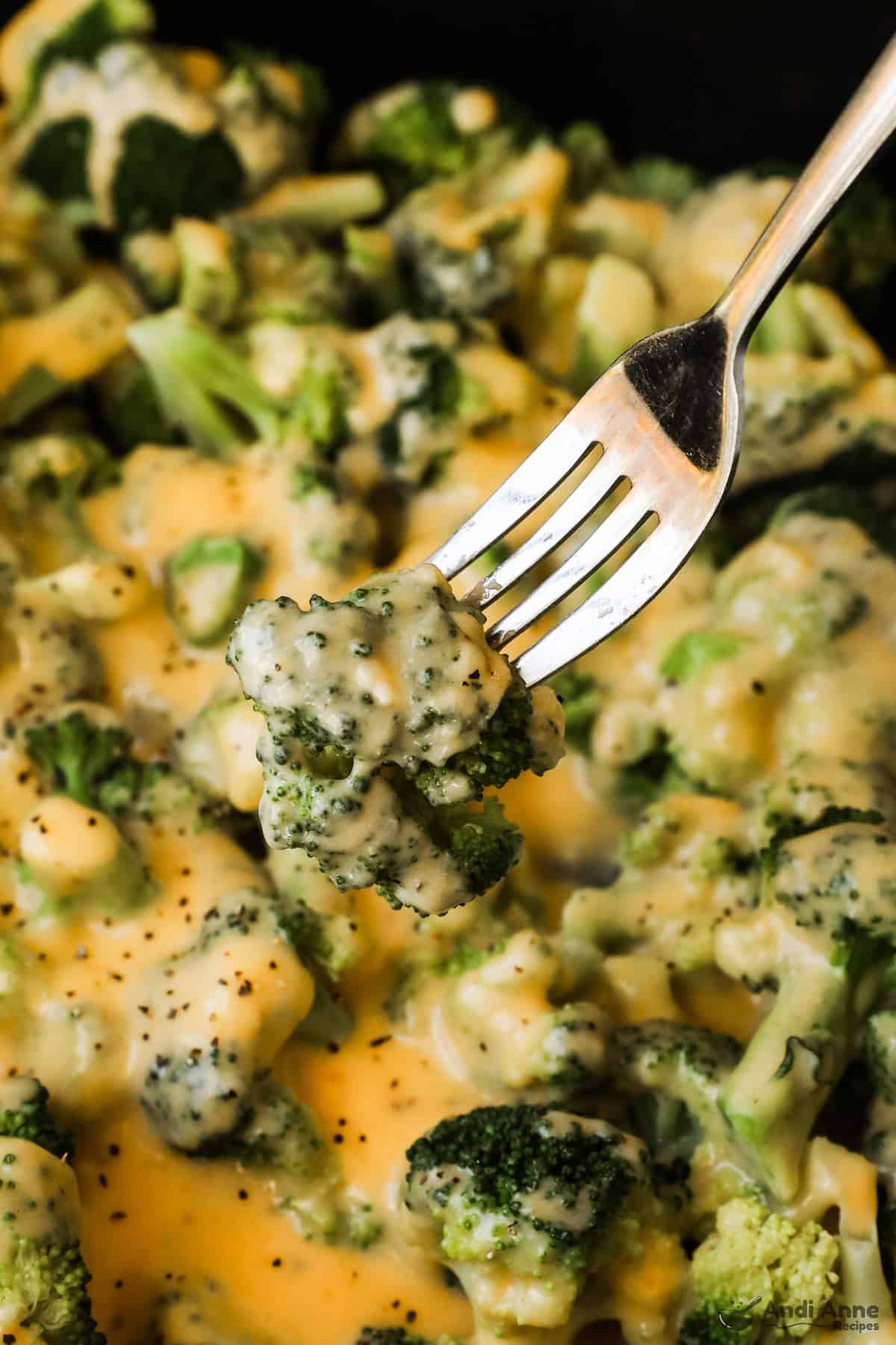 fork with close up of cheesy broccoli